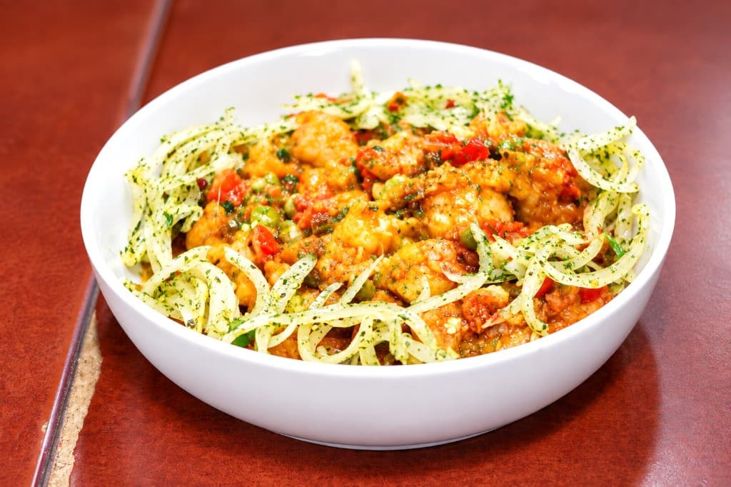 Golden BBQ Grill dish with onions and herbs in a white bowl